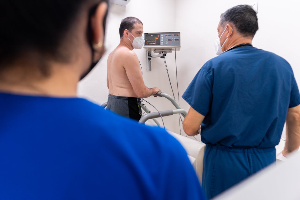 Patient undergoing a cardiology stress test with doctors monitoring in a clinic.